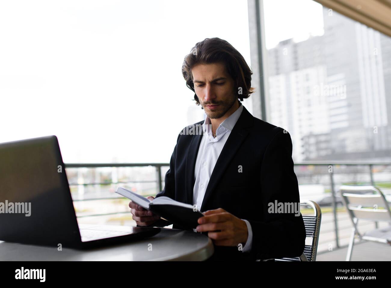 Portrait of an handsome businessman with phone, coffee cup in the city ...