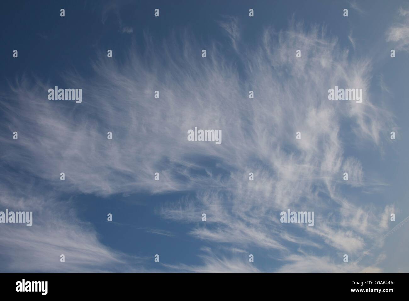 Wispy cirrus clouds high up in the sky on an autumnal evening Stock Photo
