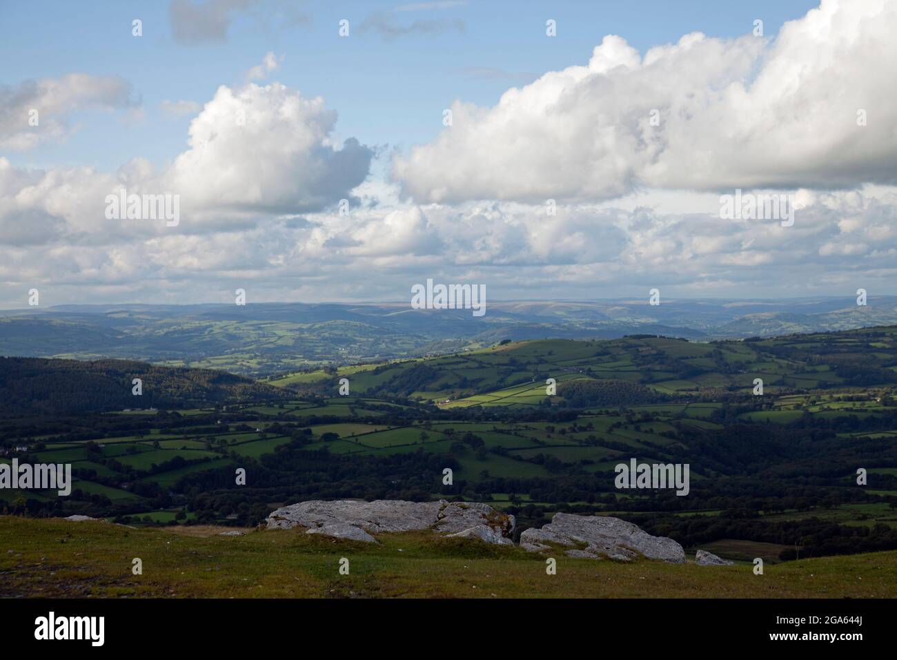 Gathering cumulus clouds on a summer's afternoon, throwing shadows over rolling Welsh hills Stock Photo