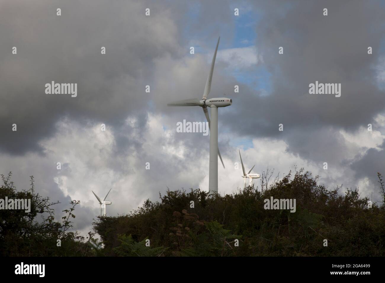 Wind turbines, standing upright and proud, on a hilltop in Neath, Wales Stock Photo