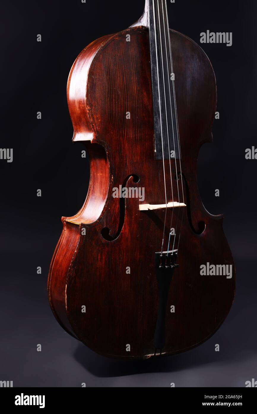 Vintage cello on dark background Stock Photo - Alamy