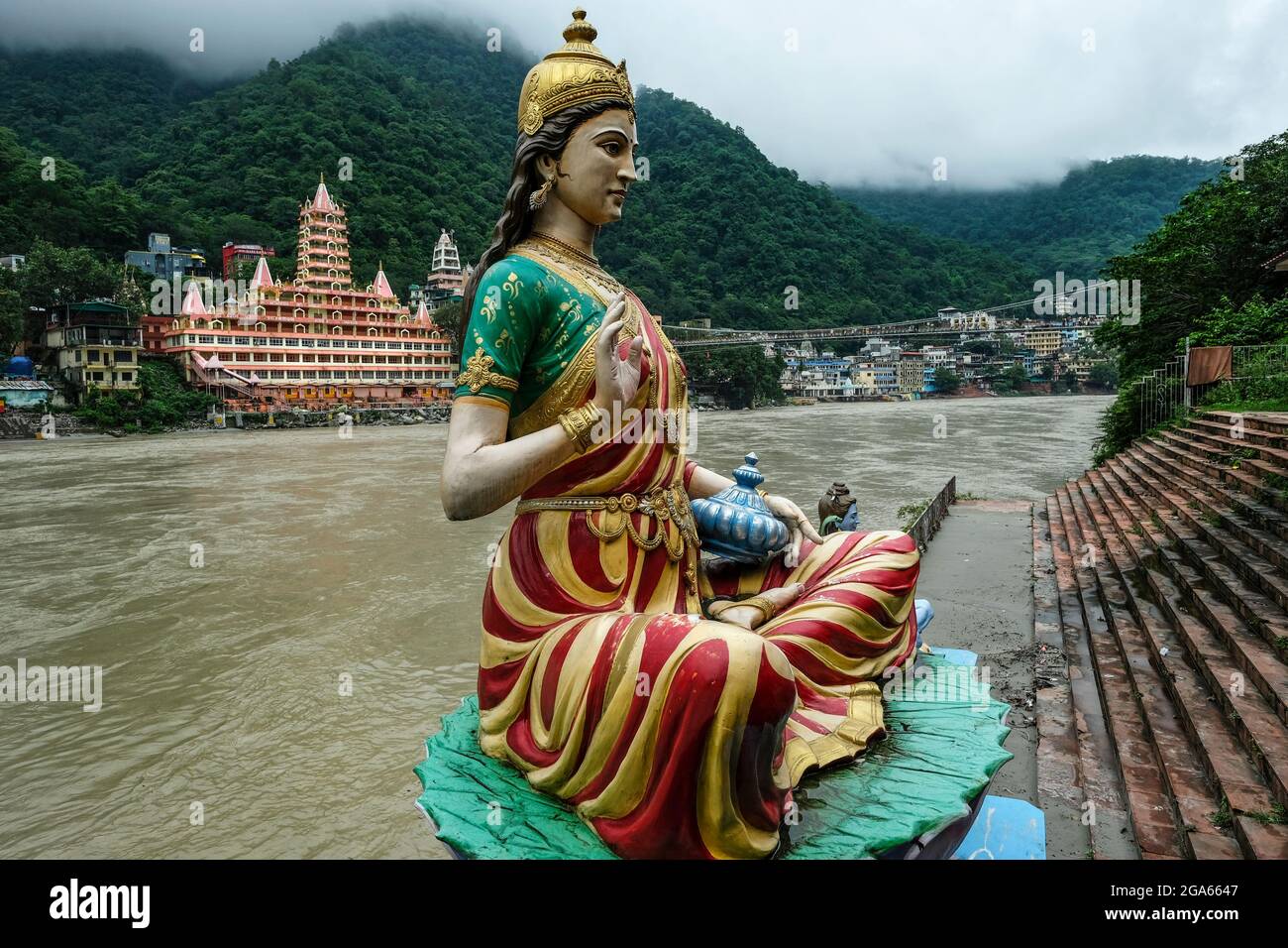 Rishikesh, India - July 2021: Views of the Swarg Niwas Temple from the Sai Ghat in Rishikesh on July 20, 2021 in Uttarakhand, India. Stock Photo
