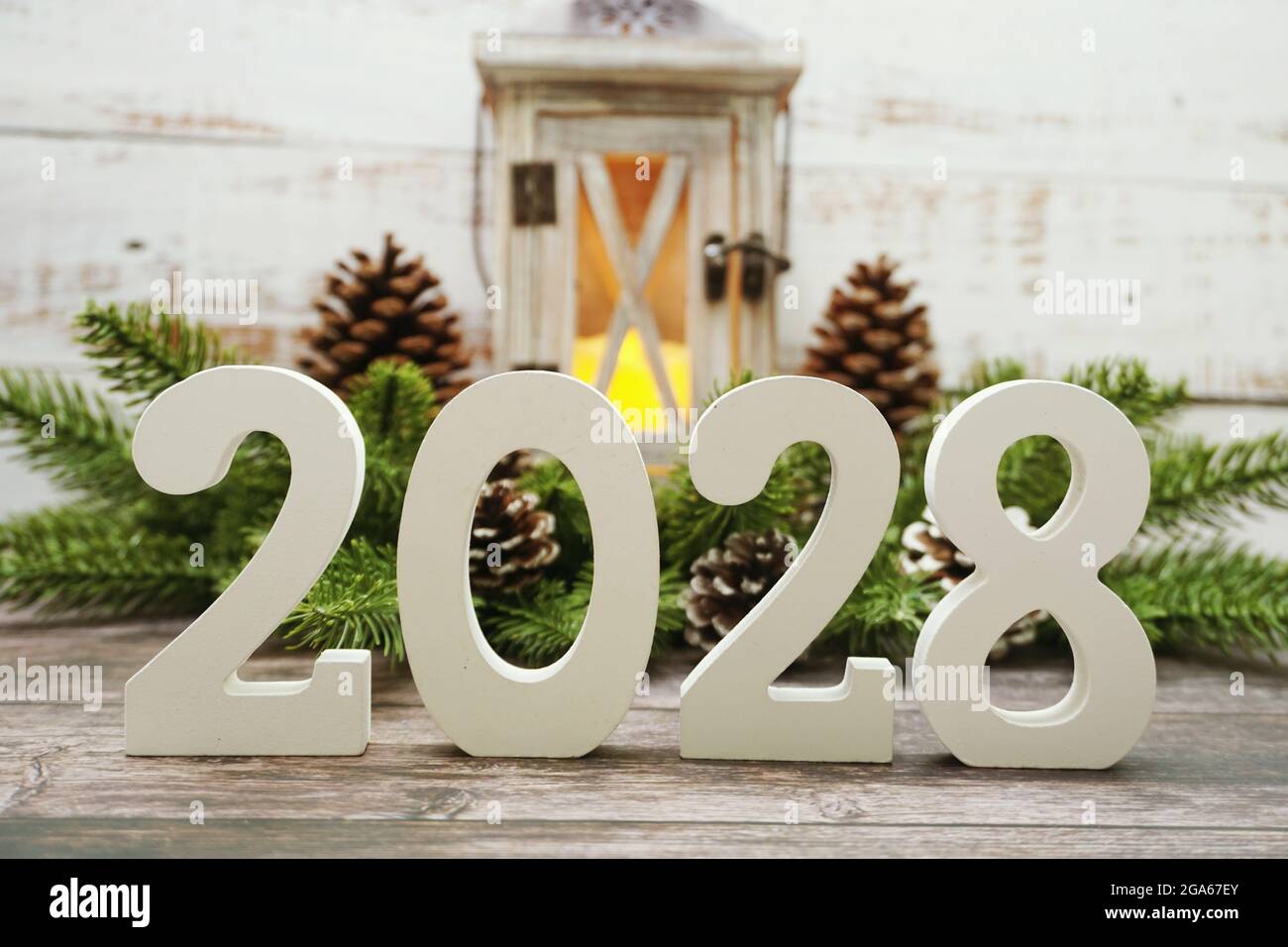 2028 Happy New Year with christmas lantern decorative with space copy on wooden background Stock Photo