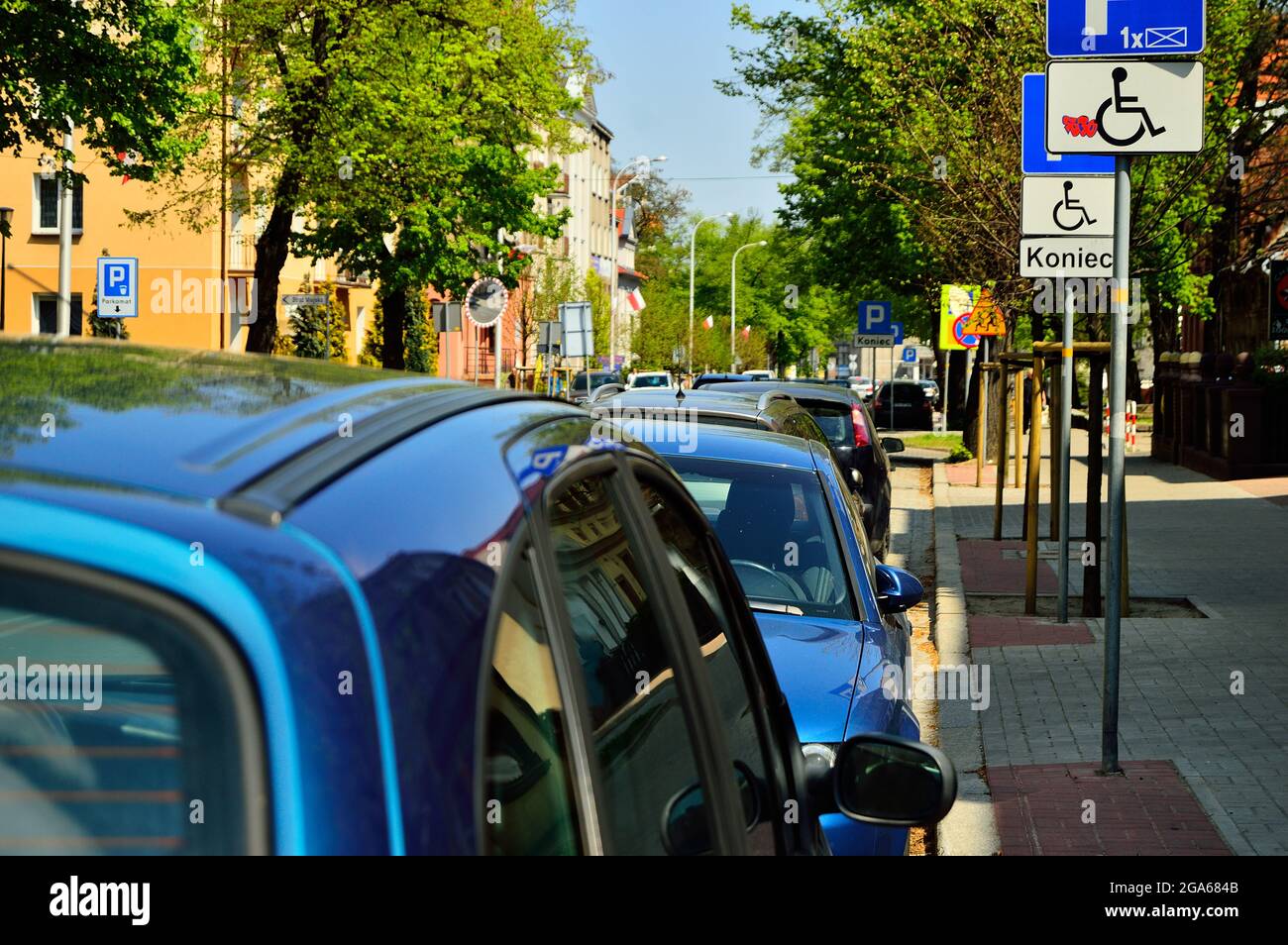 Cars standing in the parking lot, a place for a disabled person. Summer. Stock Photo