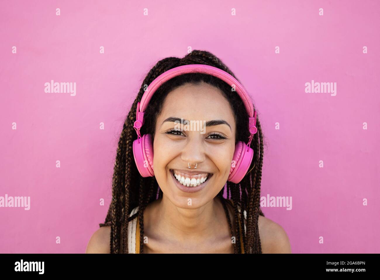Bohemian african girl listen playlist music with headphones - Focus on face Stock Photo