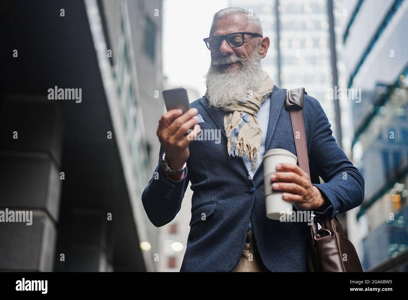 Old man walking smart phone hi-res stock photography and images - Alamy