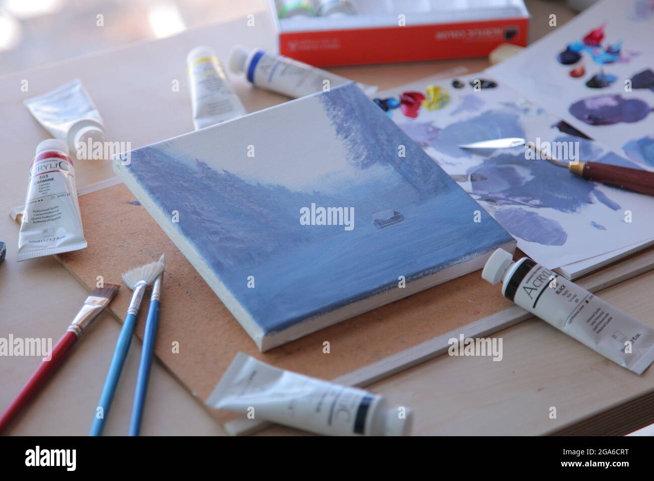 Notebook and paints on the desk Stock Photo