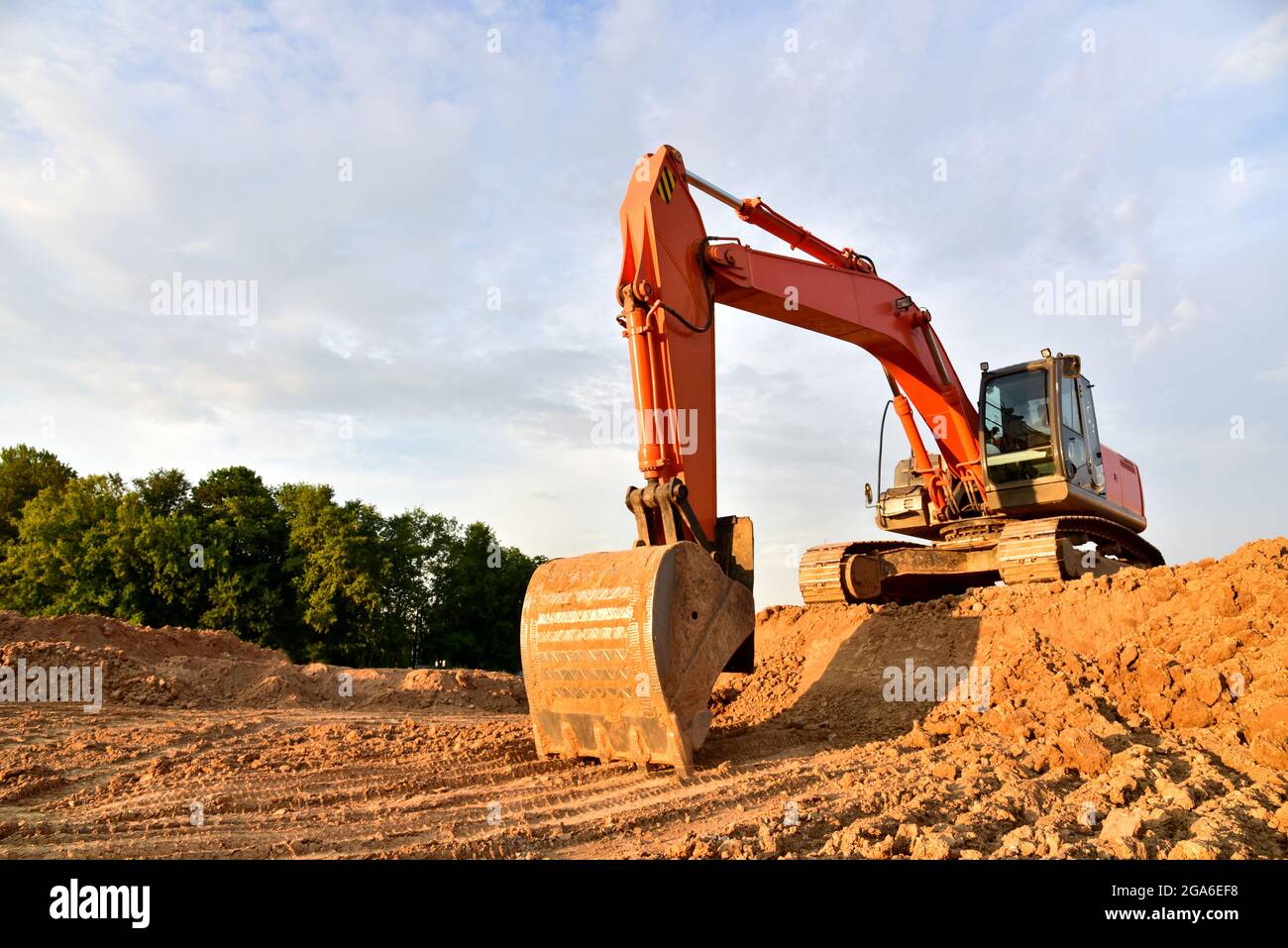 Excavator dig sand at the openpit. Heavy machinery working in the
