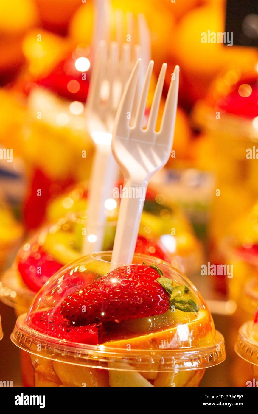 https://c8.alamy.com/comp/2GA6EJG/vertical-shot-of-fresh-cut-mixed-fruits-in-plastic-cups-with-plastic-forks-in-a-market-2GA6EJG.jpg