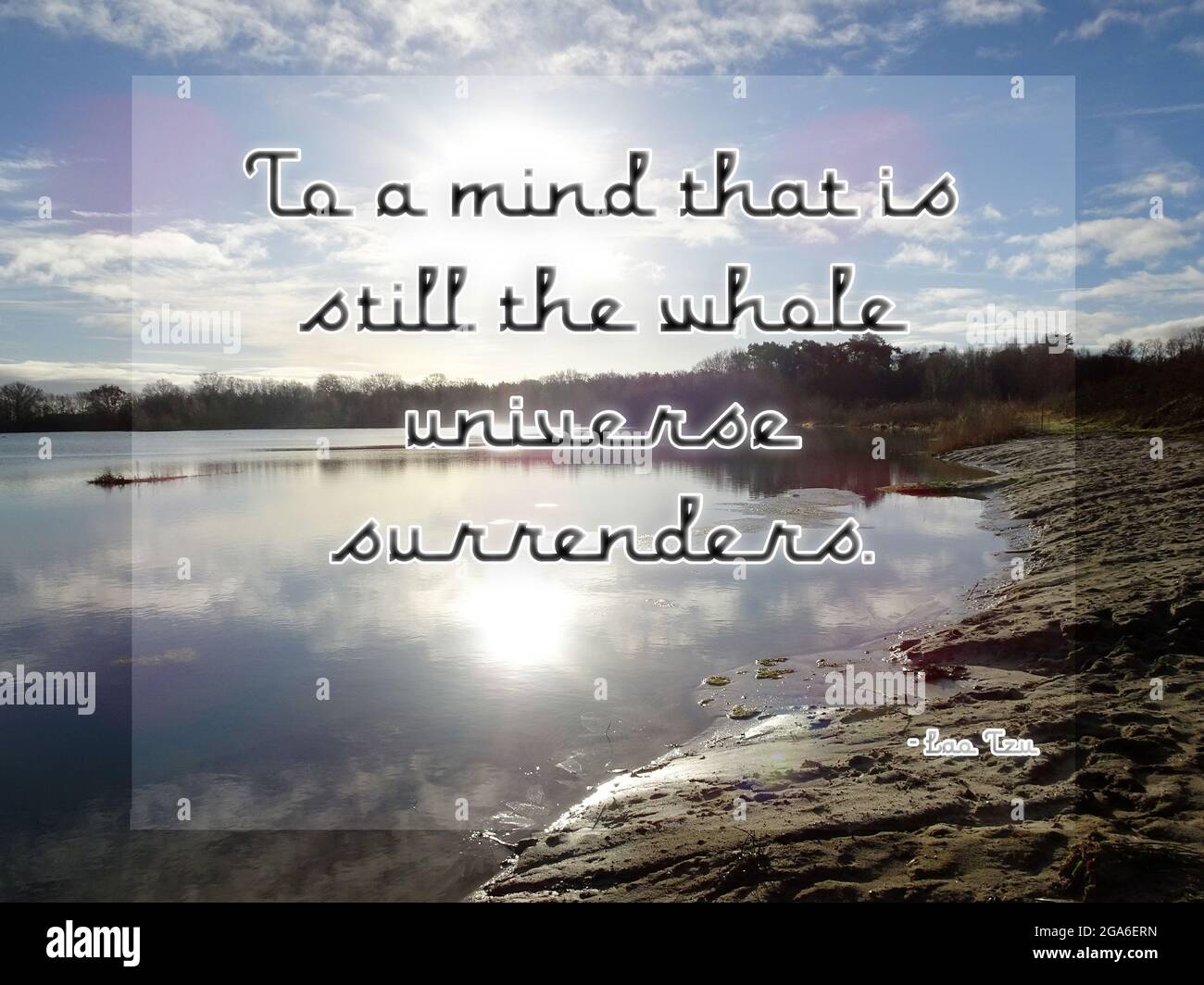 To a mind that is still the whole universe surrenders. Quote from Lao Tzu. Photo of a lake with reflections of a clouded sky. Stock Photo