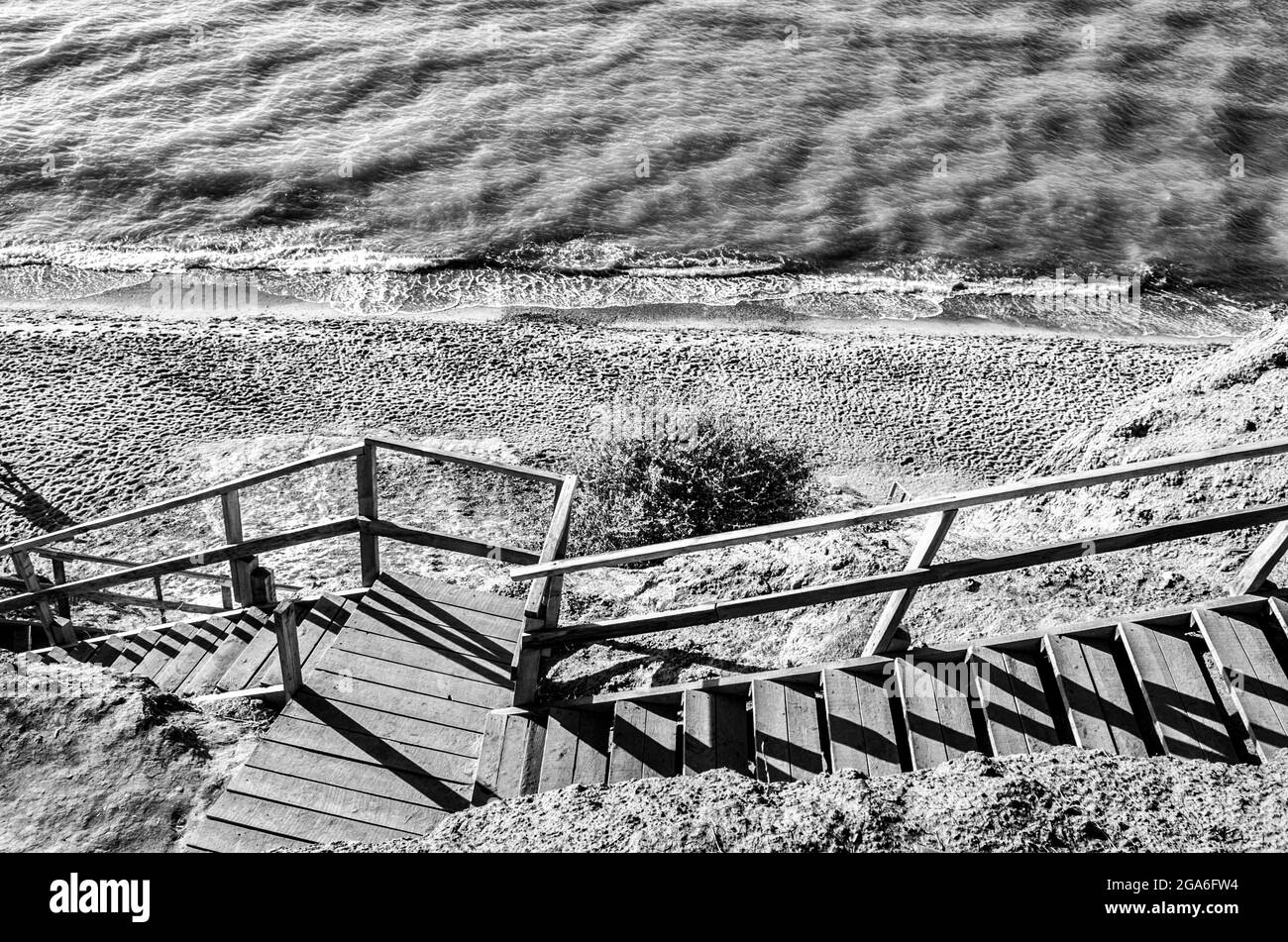 Landscape of wooden stairs to the sea. Black and white concept photo. Stock Photo