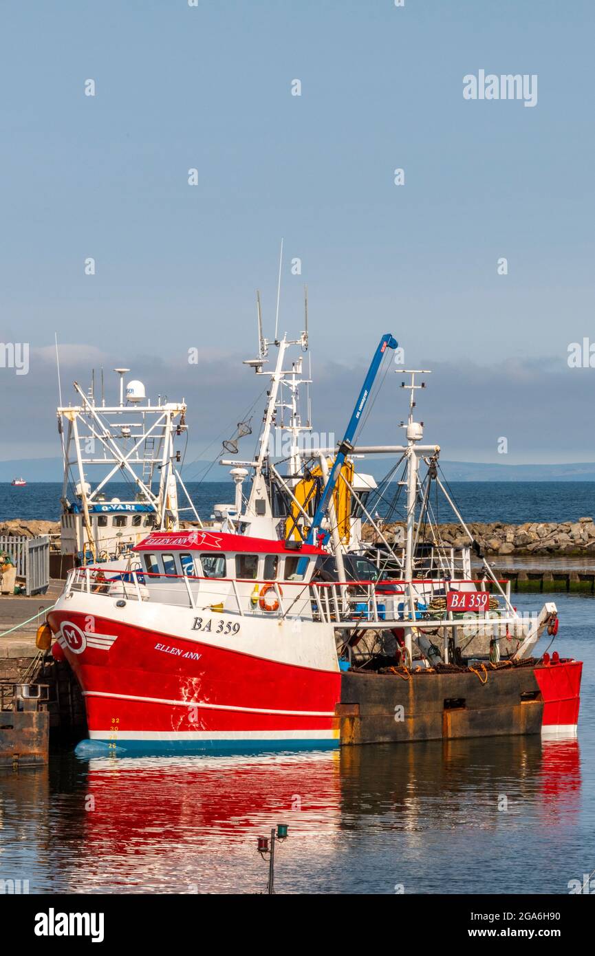 Fishing trawlers and boats alongside the wall berthed in Girvan harbour