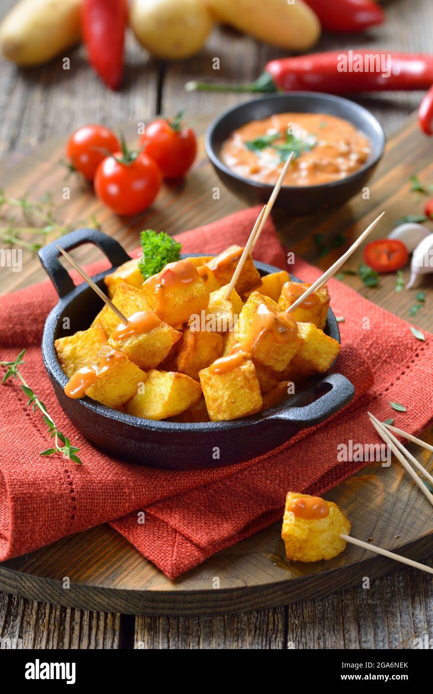 Spanish patatas bravas with spicy chili sauce, a traditional appetizer and bar food Stock Photo