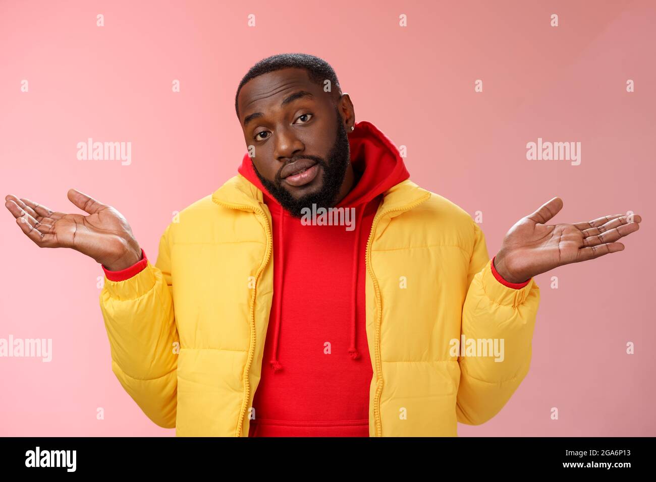 Indoor shot black bearded 25s guy shrugging hands raised sideways ...
