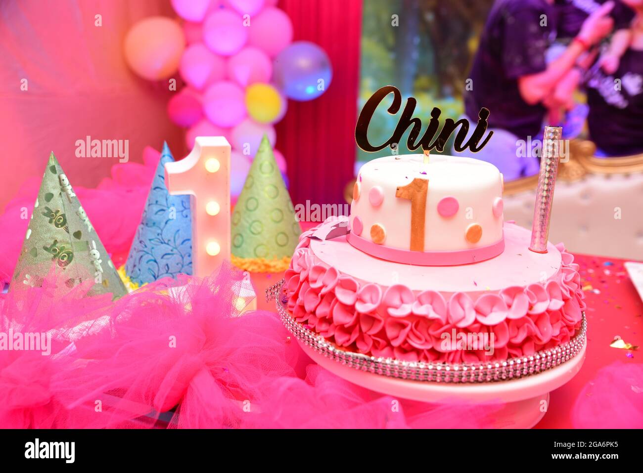 Birthday cake with one candle on pink background Stock Photo - Alamy