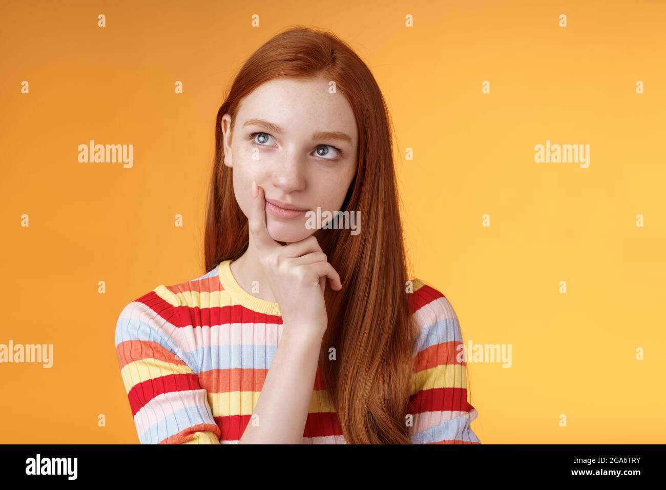 Creative thoughtful young smart redhead female student thinking ideas