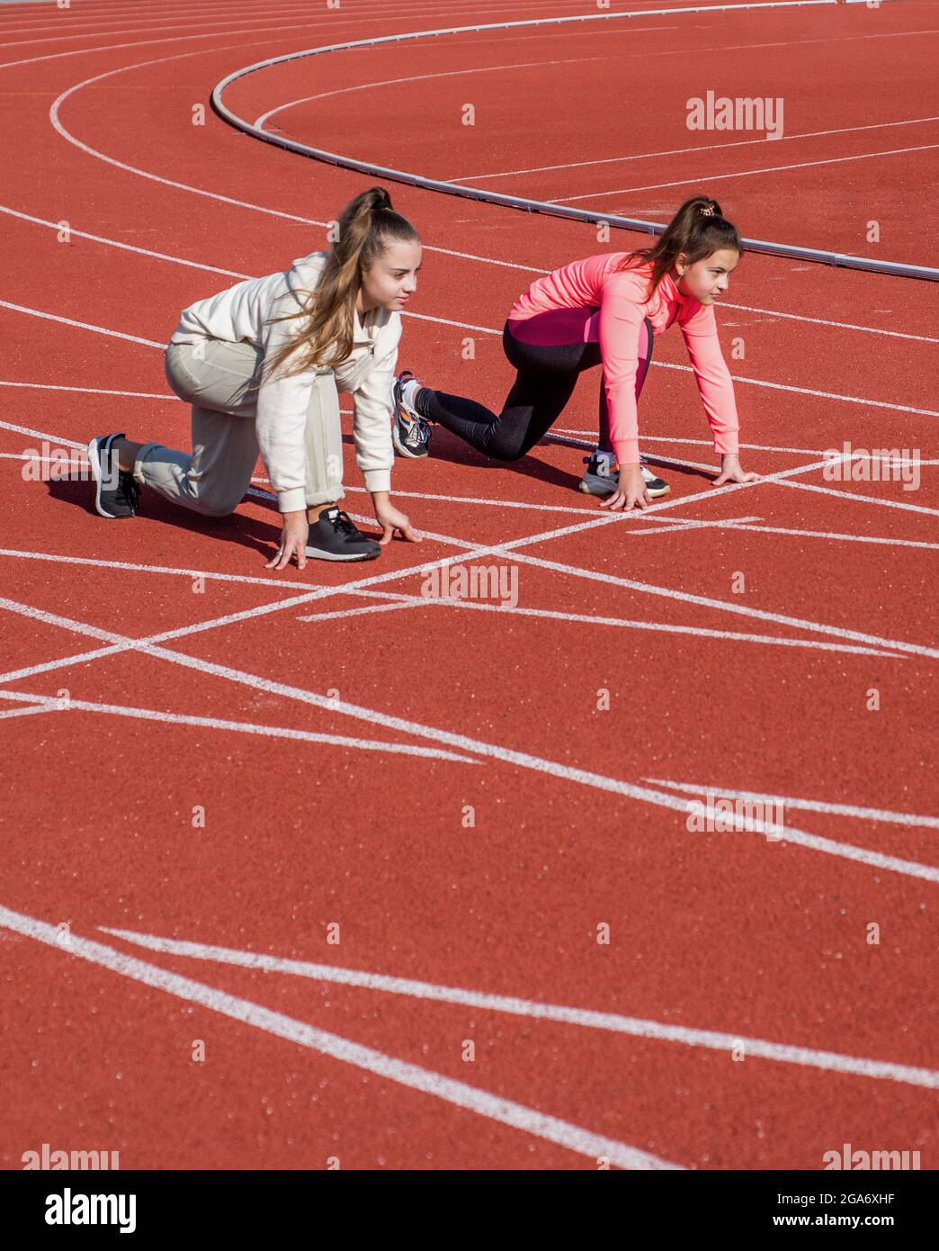 Toe the starting line. Athletic children in starting position. Running.  Athletics. At the start Stock Photo - Alamy