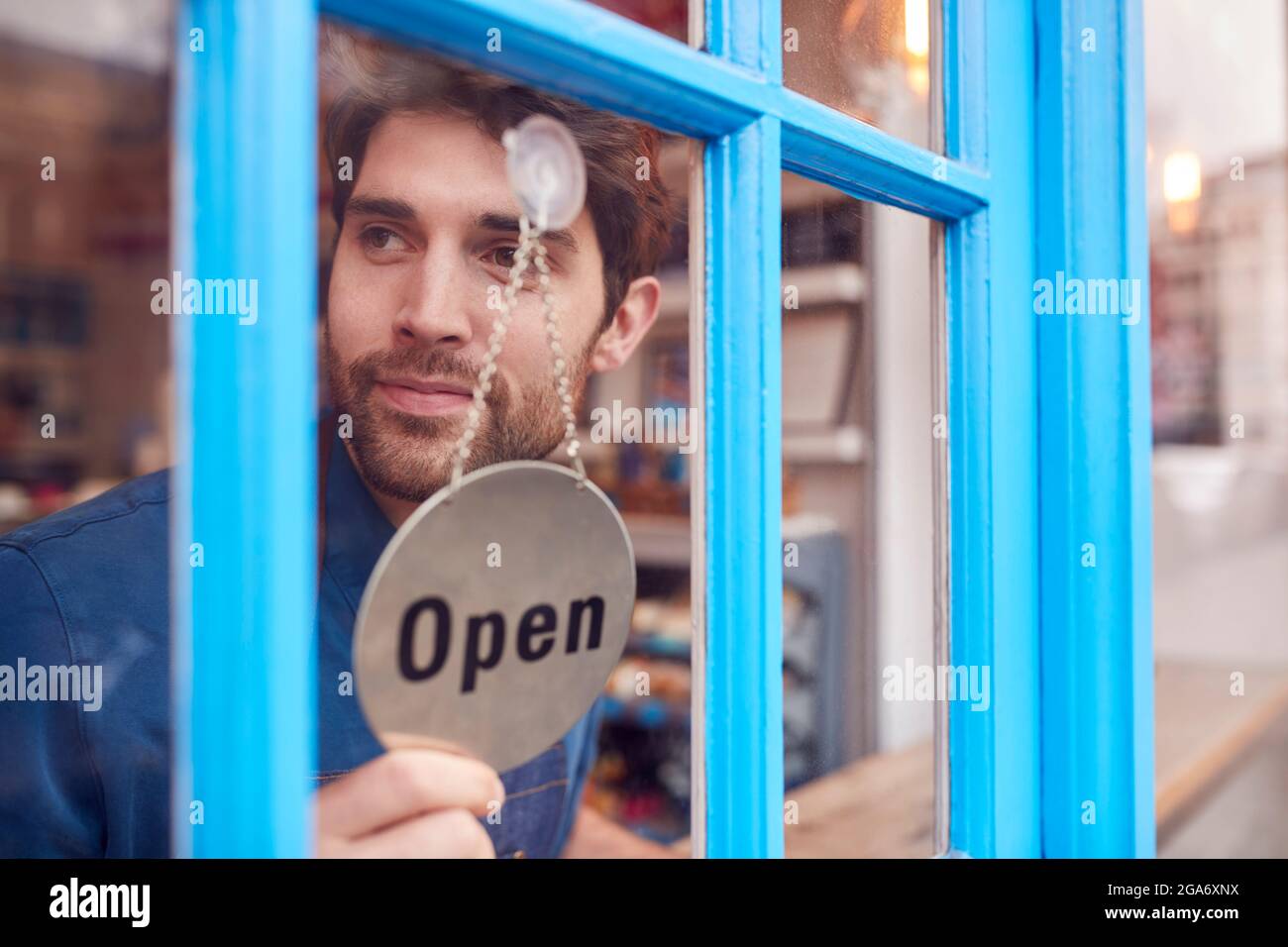 Man turning close sign to open sign hires stock photography and images