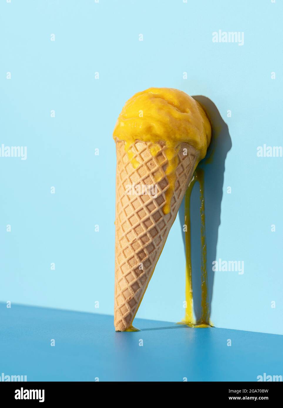 Melted Mango Ice Cream Dripping On A Blue Wall Mango Ice Cream In A Waffle Cone In Bright Light 8003