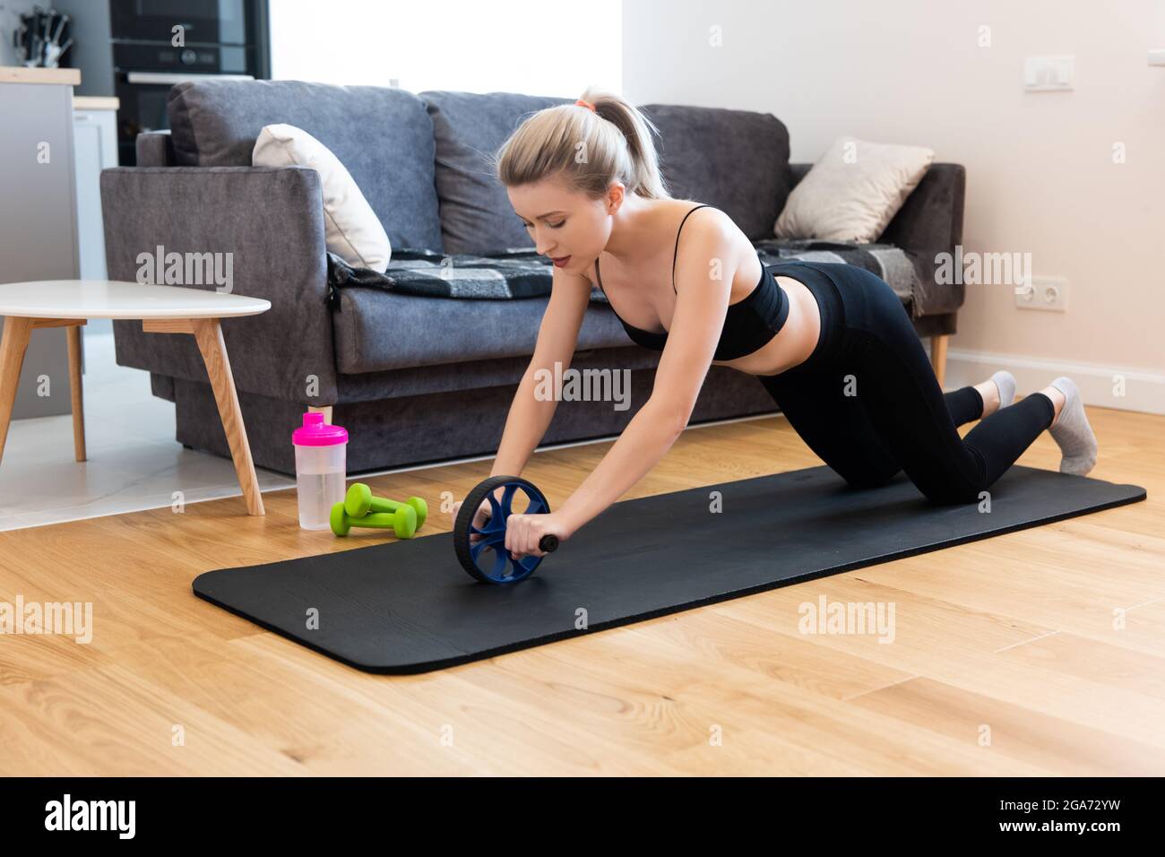Woman do exercise with wheel roller on fitness mat Stock Photo - Alamy
