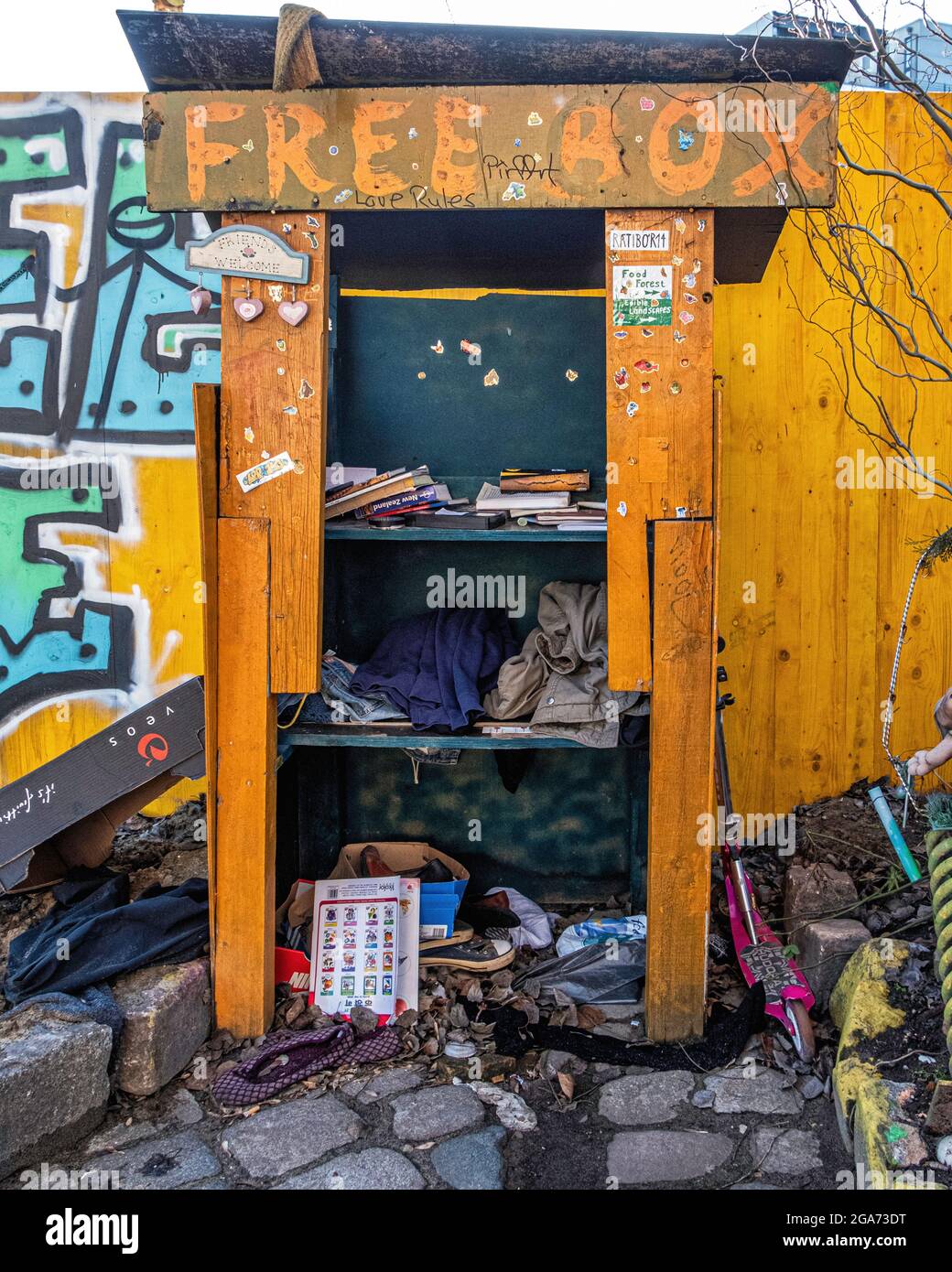 Free box shares clothes, books and toys with residents of  Teepeeland informal squatters commune in Kreuzberg-Berlin, Germany. Stock Photo
