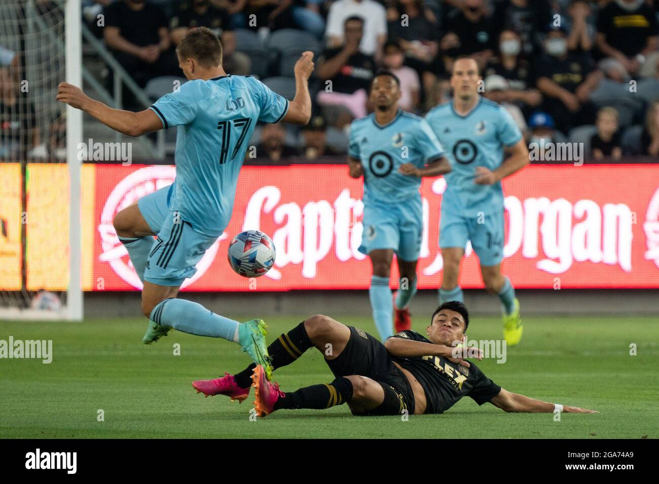Minnesota United midfielder Robin Lod (17) loses possession from a slide tackle by Los Angeles FC defender Marco Farfan (32) during a MLS match, Wedne Stock Photo