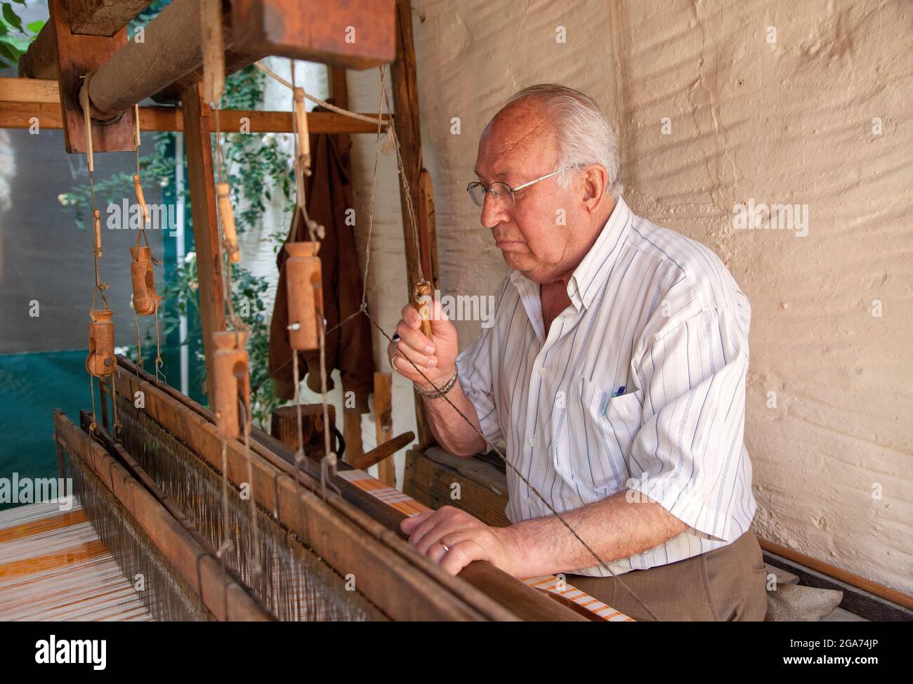 Buldan,Denizli/Turkey - 07/06/2014:A weaver master works at a loom Stock Photo