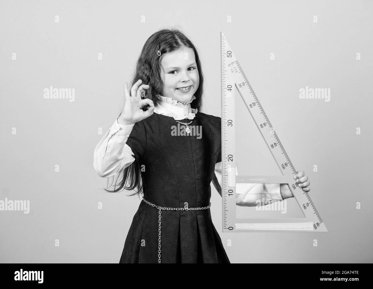 Smart and clever concept. Pupil cute girl with big ruler. School ...