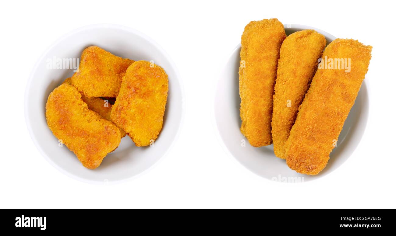 Fried vegan nuggets and fishless fingers, in white bowls. Nuggets and fishless sticks based on soy protein, breaded and crispy coated and fried. Stock Photo