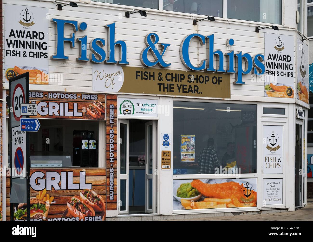 Fast food outlet with multiple signs in east coast seaside resort. UK