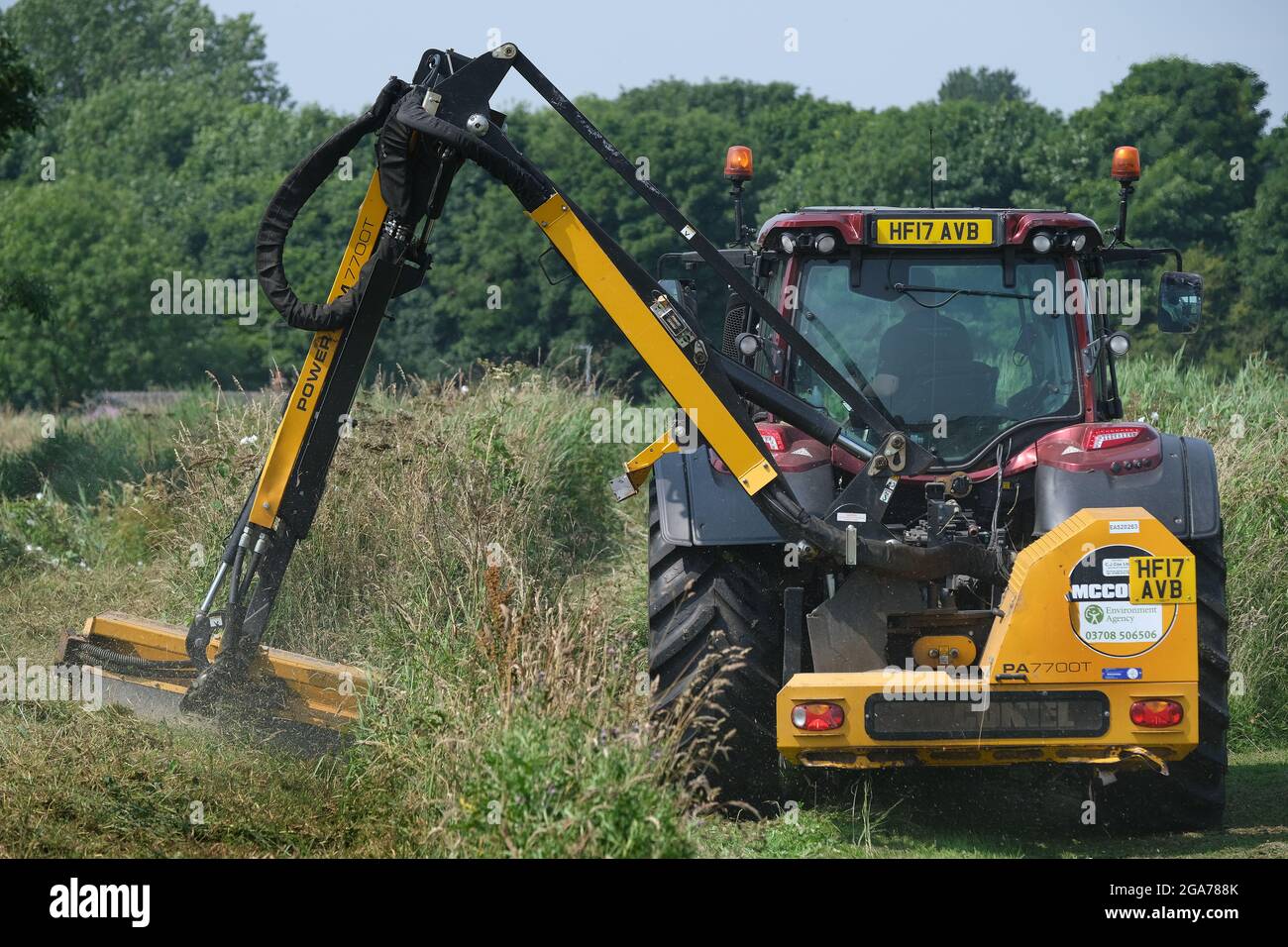 Environmental agency team cutting grass and working on dykes in rural area. Stock Photo