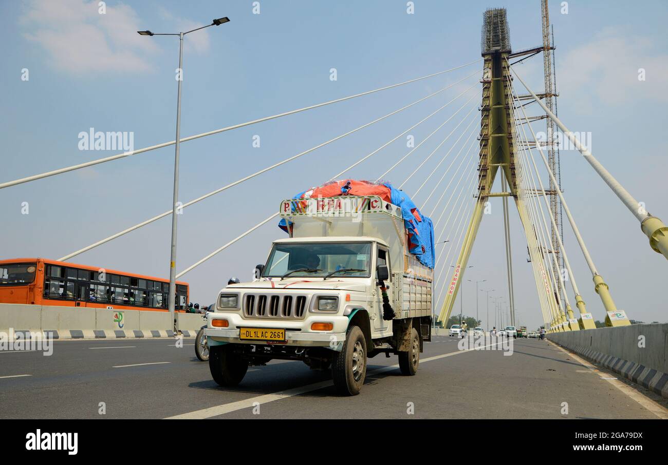 Public transport crossing the Signature Bridge Wazirabad at New Delhi,India Stock Photo
