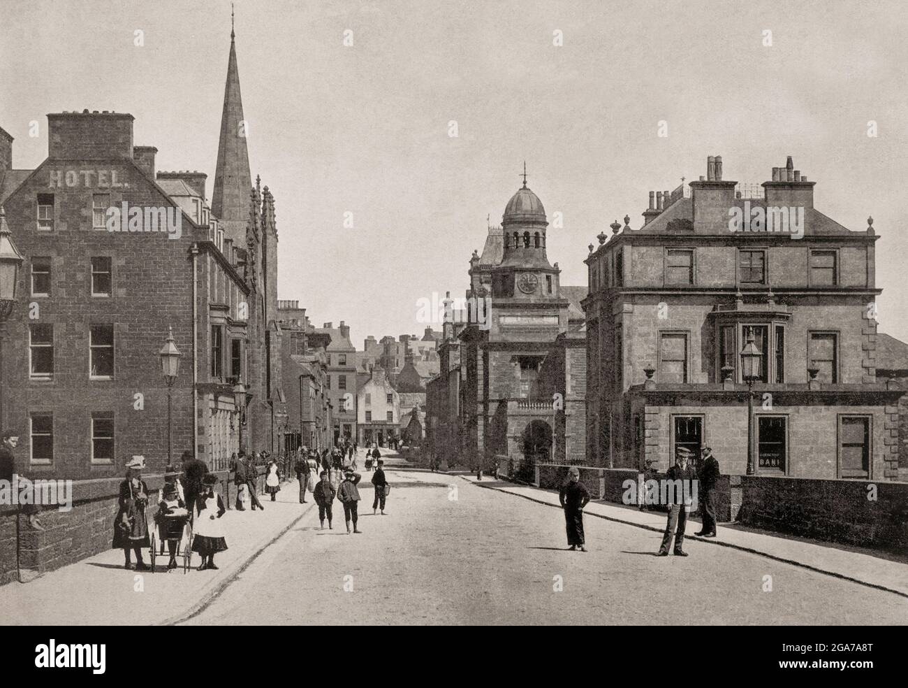 A late 19th century view of Bridge Street in Wick, a town and royal burgh in Caithness, in the far north of Scotland. The town straddles the River Wick and extends along both sides of Wick Bay. Stock Photo