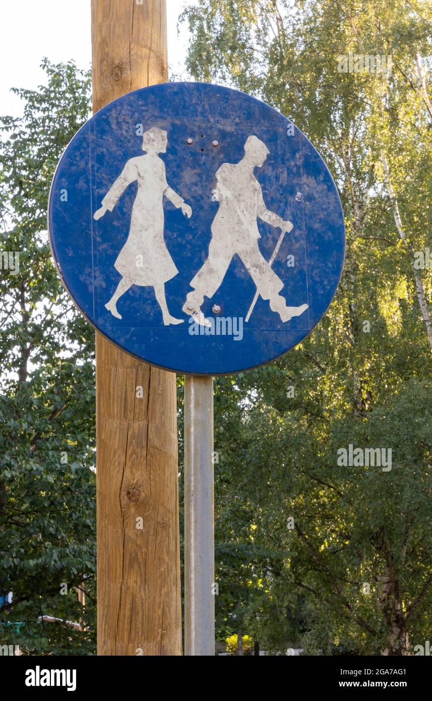 Obsolete, dirty and worn footpath sign on the grounds of Koskela Senior Centre (previously Koskela Hospital). Stock Photo
