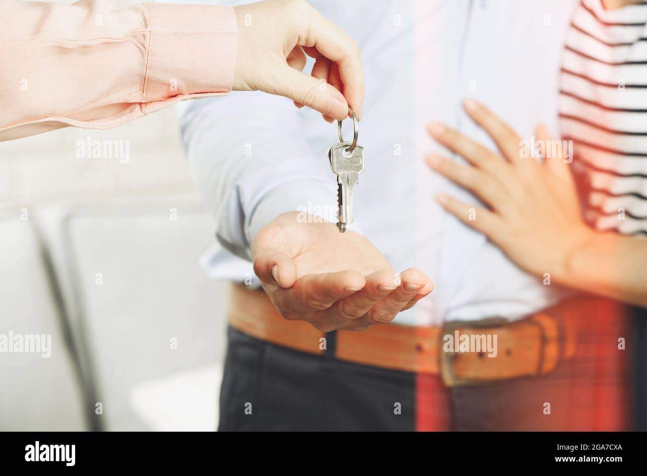 Real estate agent giving keys to young couple Stock Photo - Alamy