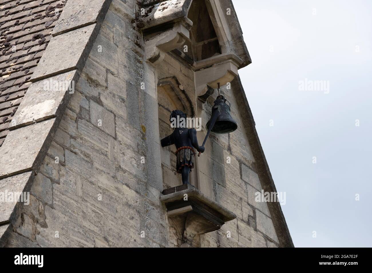 Rear view of Black Boy clock mechanism depicting a black boy hitting a 18th century clock chime bell with a club. Stroud, Gloucestershire. 29 July 2021. Stock Photo
