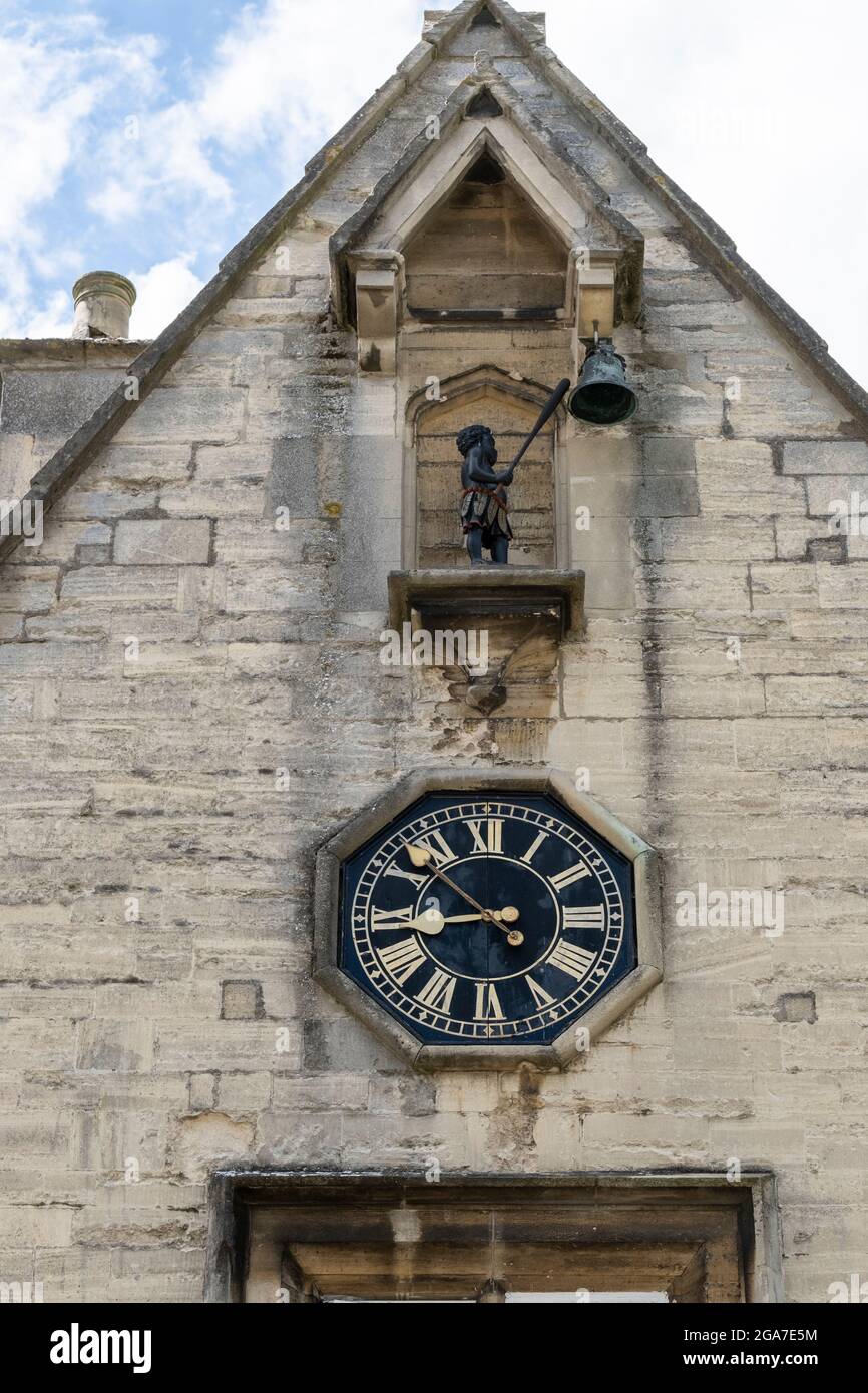 The Black Boy clock on front of Black Boy House, Stroud. Gloucestershire. The clock mechanism shows a depiction of a black boy statue hitting the clock bell with a club. 29 July 2021. Stock Photo