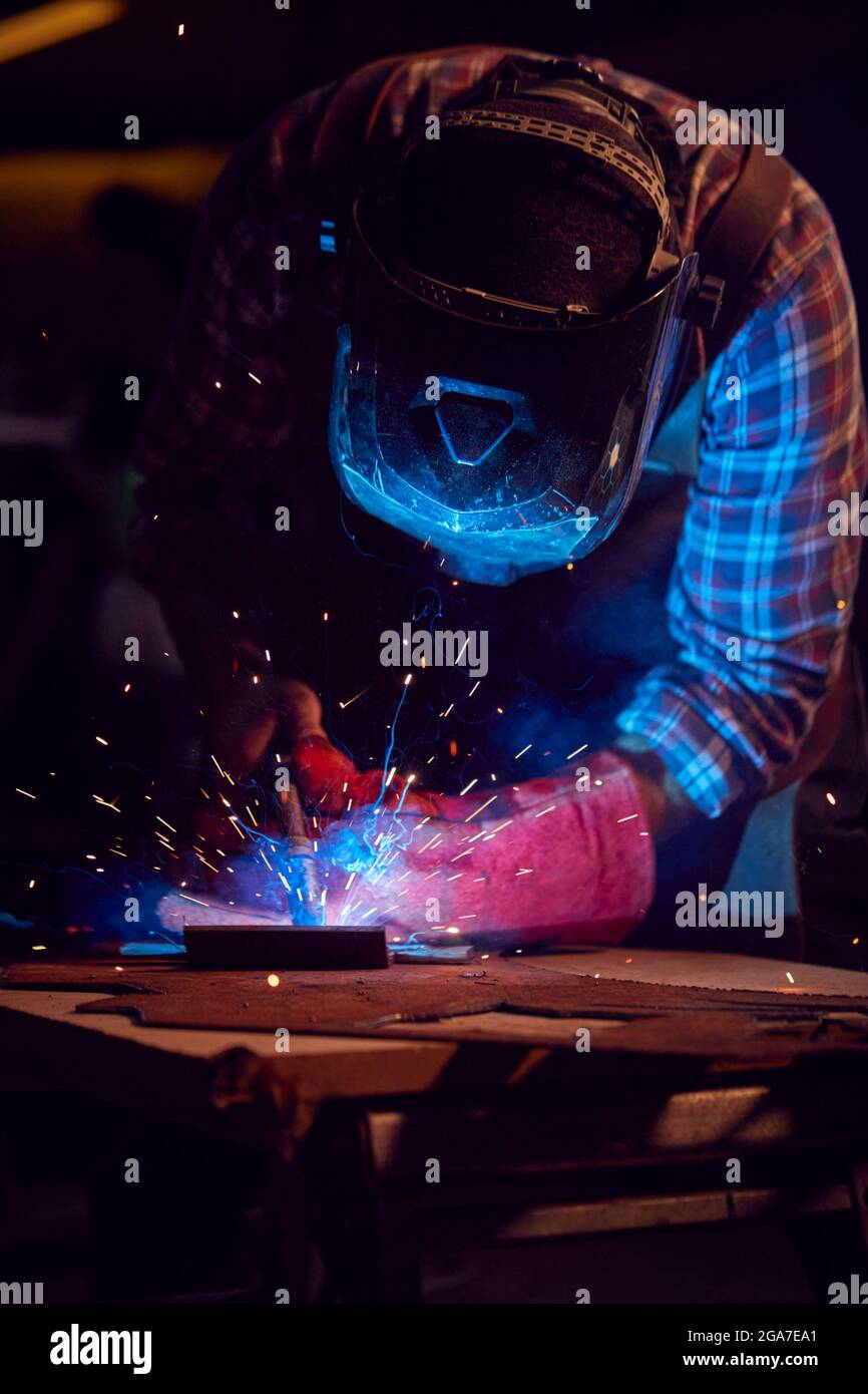 Male Blacksmith Wearing Protective Safety Visor Arc Welding Metalwork