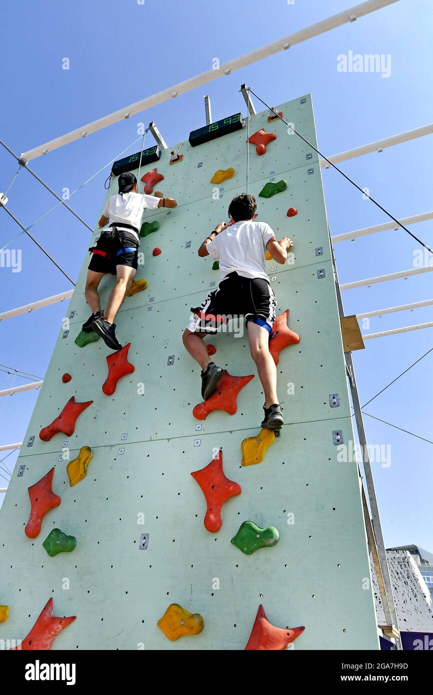 Practicing on a climbing wall, during a sports summer camp, in Milan. Stock Photo