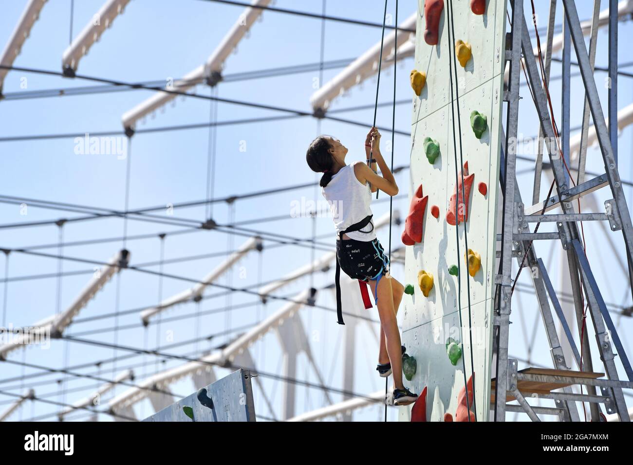 Practicing on a climbing wall, during a sports summer camp, in Milan. Stock Photo