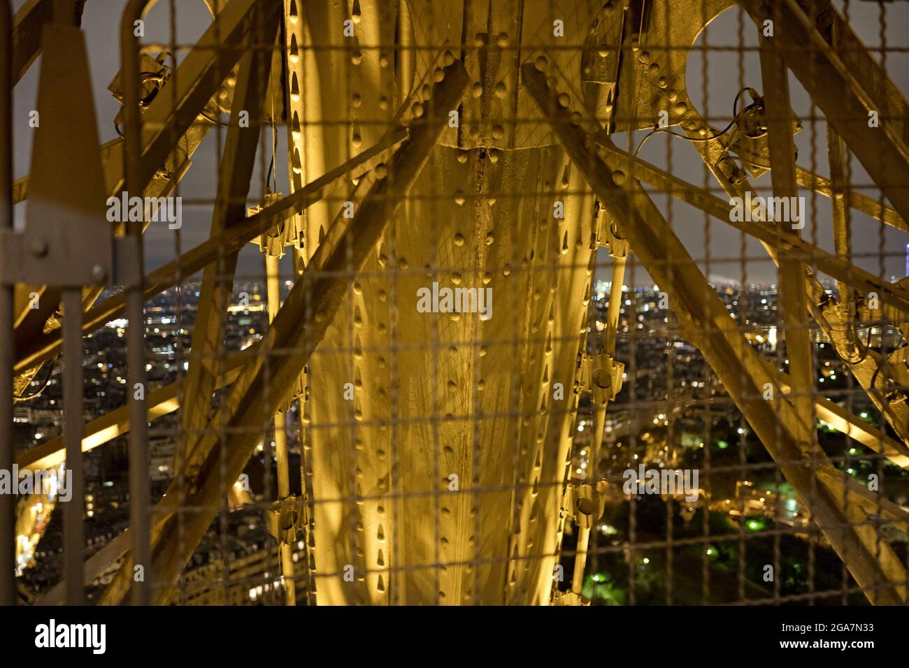 Iron, steel and copper pipes of the famous Tour Eiffel seen at night, in Paris. Stock Photo