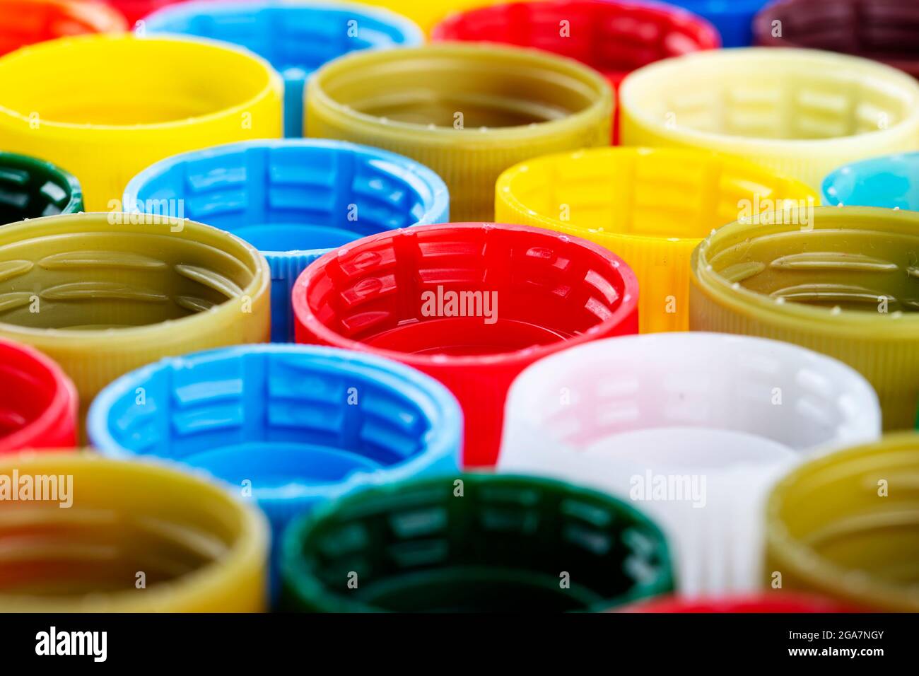 Plastic bottle caps background. Cap material is recyclable. Recycling