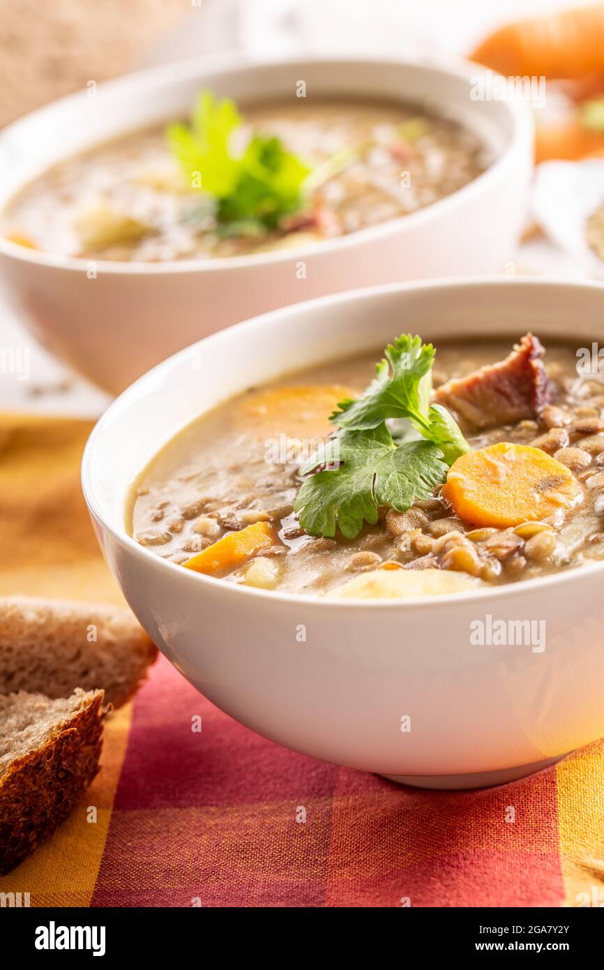 Lentil soup with pieces of smoked pork neck, carrots, potatoes and