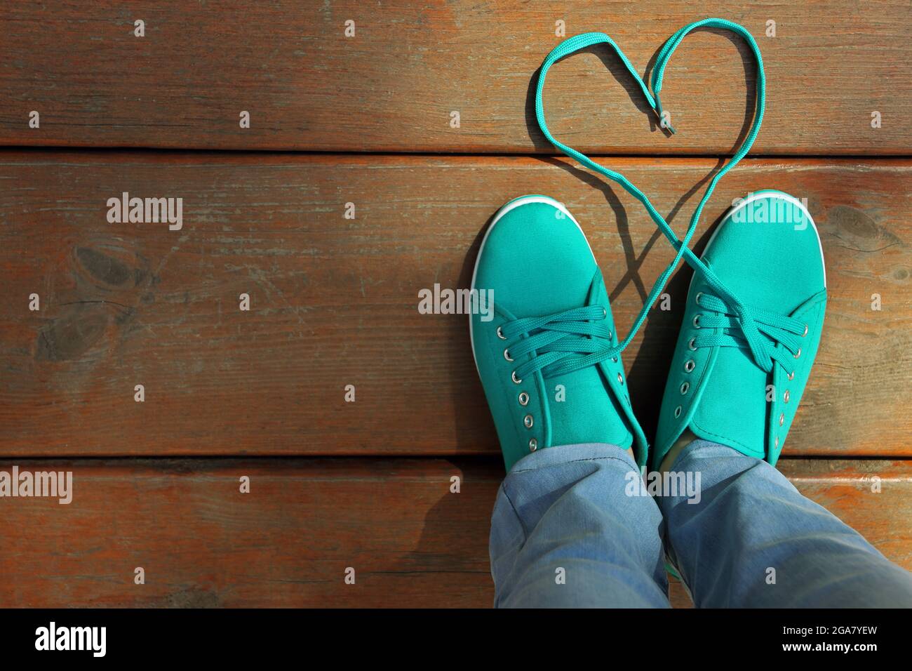 Female feet in gum shoes on wooden floor background Stock Photo Alamy