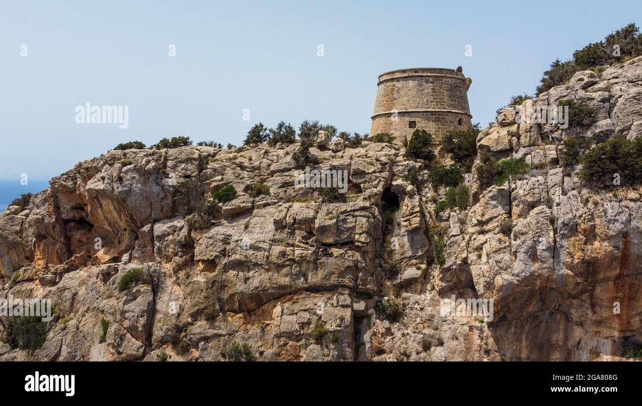 Torre des Savinar, a medieval defensive tower in the west of Ibiza island in the Balearic Islands, Spain - Built at the top of a rocky cliff Stock Photo