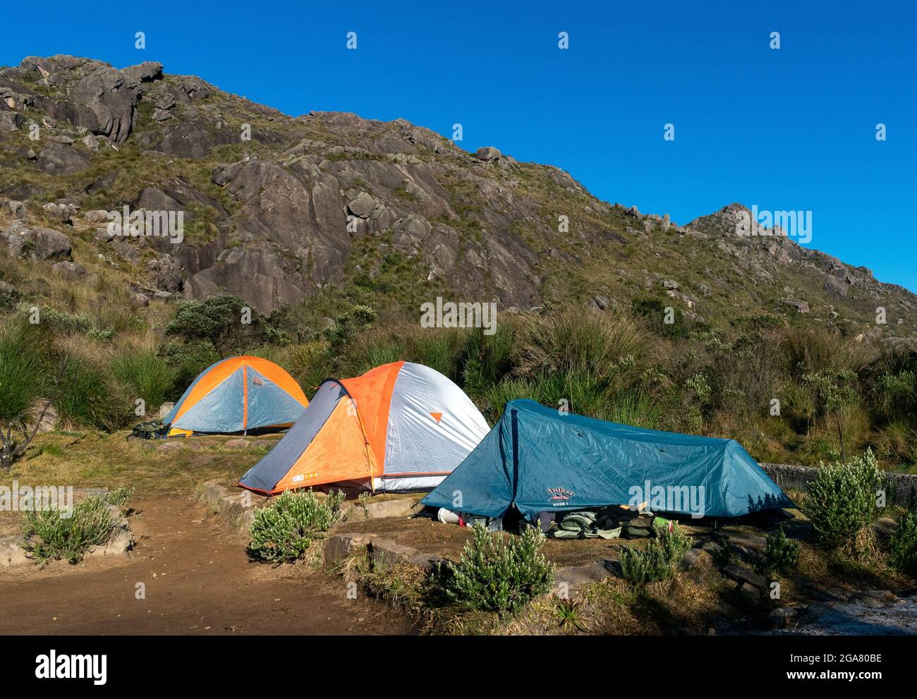 camping site with tents in altitude scenery background Stock Photo