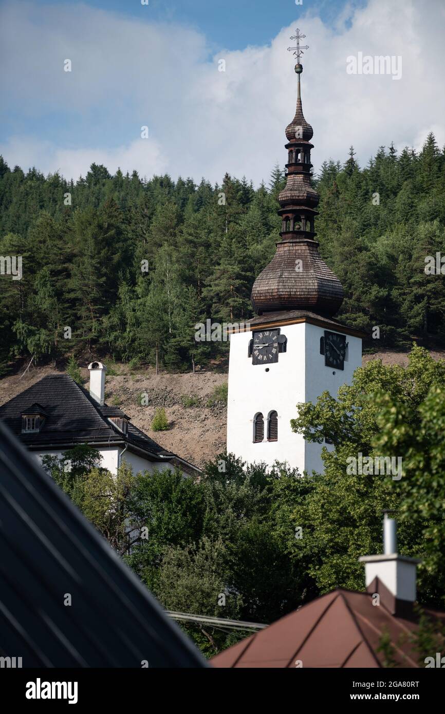 Tower of Spania Dolina church surrounded by trees, Slovakia Stock Photo