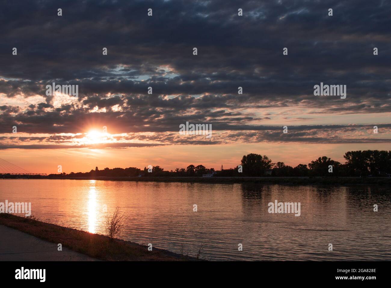 Colorful sunset on river Danube, Komarom, Hungary Stock Photo