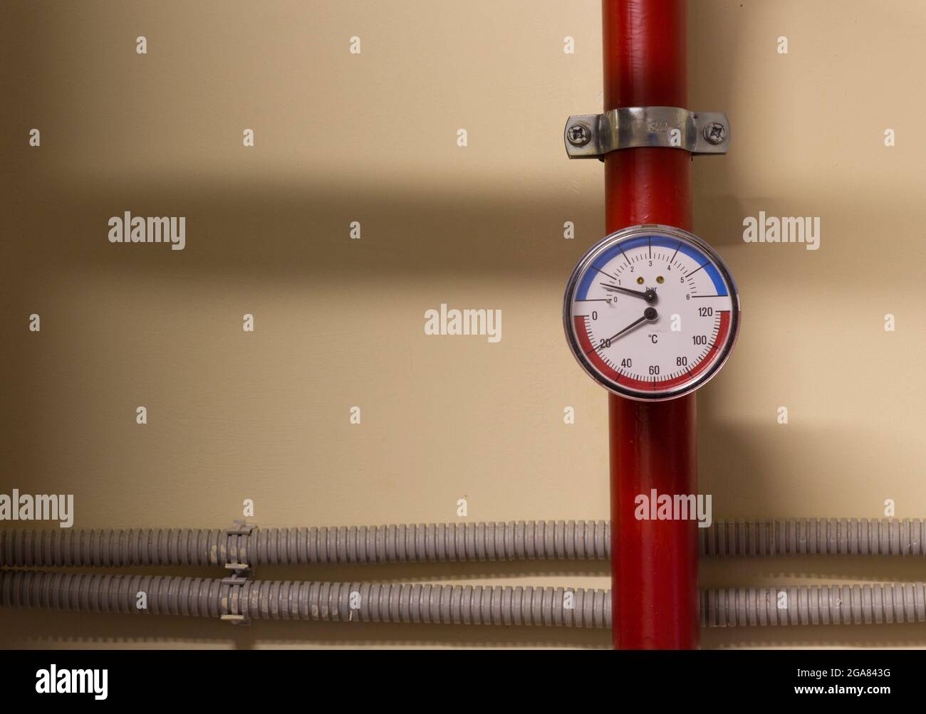A number of identical manometers stand on plastic pipes with red valves Stock Photo