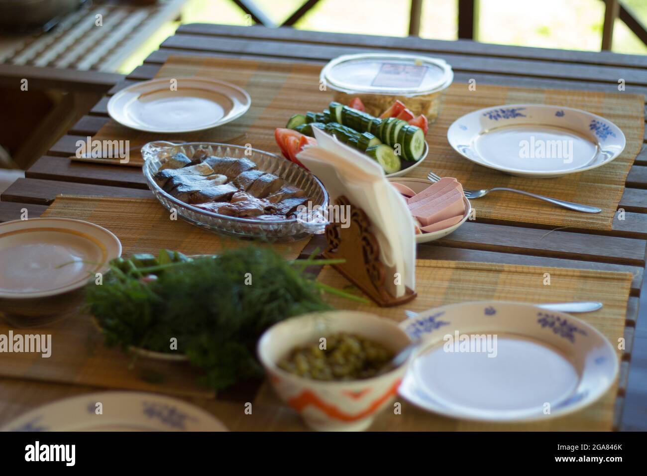 Dining table served for dinner for a family of four Stock Photo - Alamy